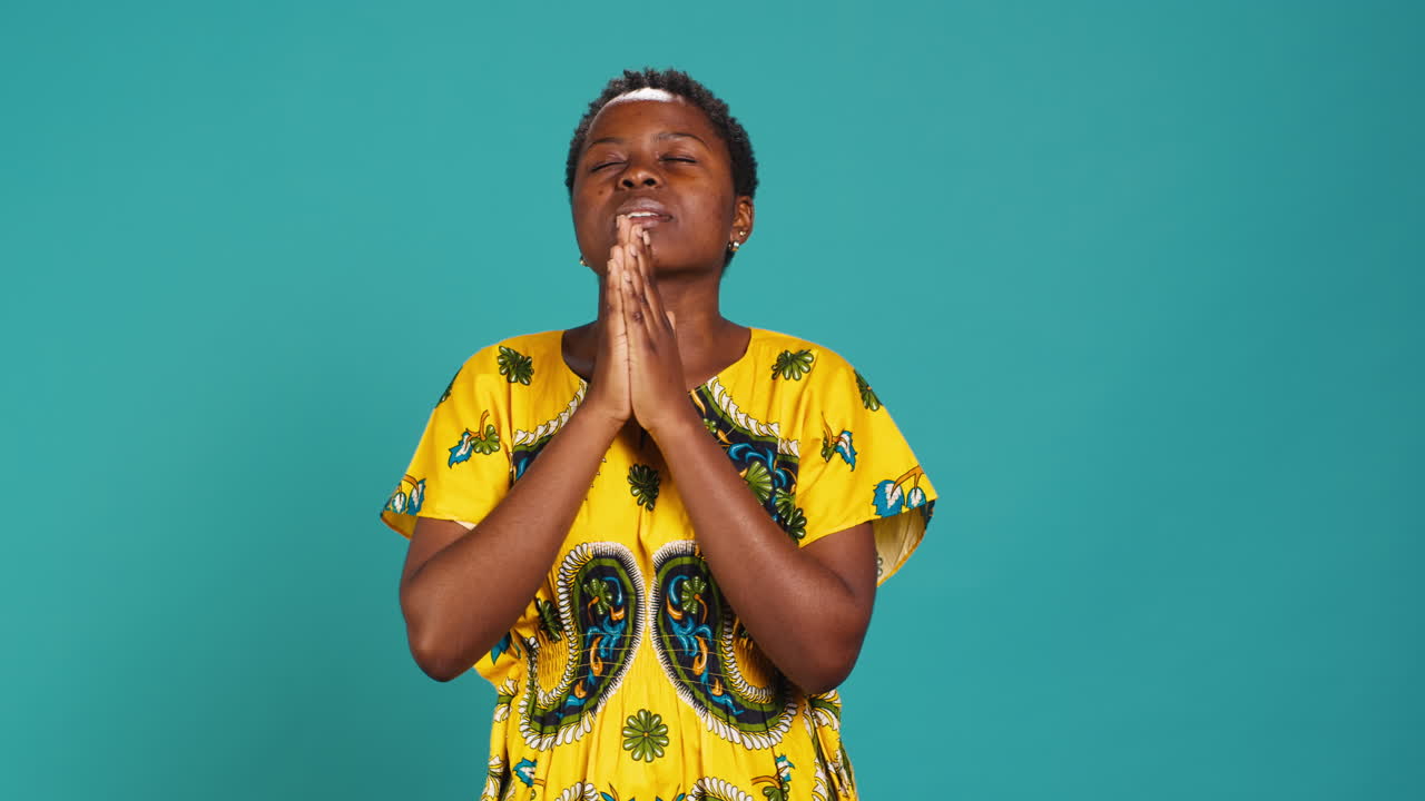 Spiritual hopeful woman holding hands in a prayer and having belief in Jesus