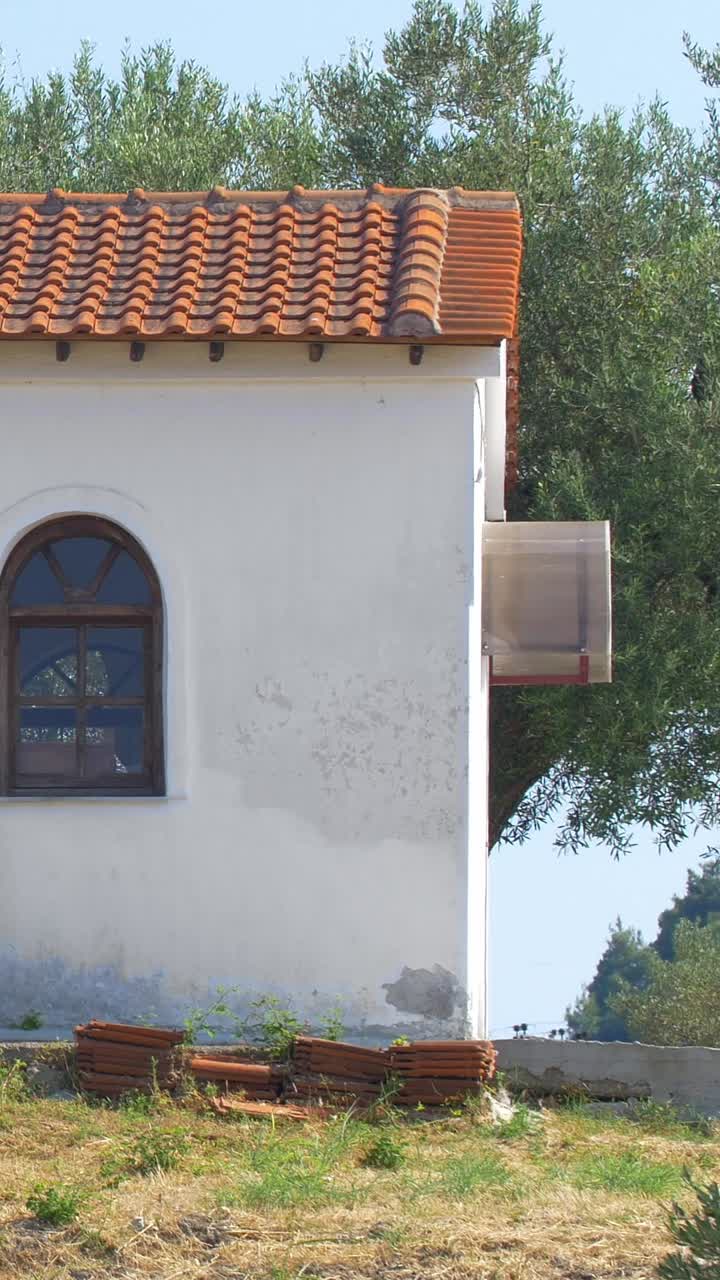 Exterior of a building with a tiled roof and arched window