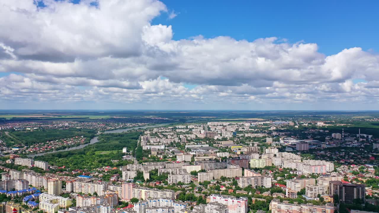 Beautiful cityscape. Panorama of a city under white clouds. Modern downtown in summer. Aerial view.