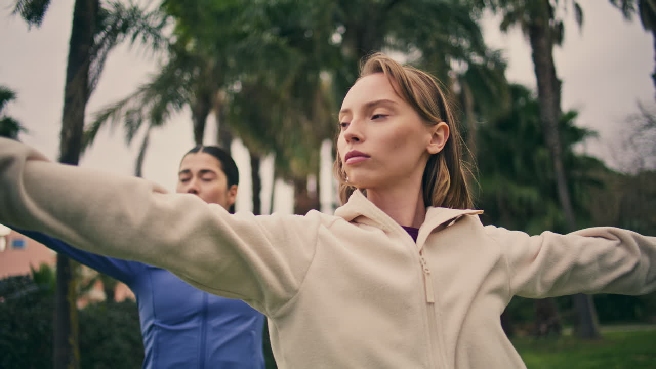 Flexible yogini morning gymnastic routine. Closeup women training yoga at park