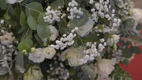 close up of white floral arrangement with roses and baby's breath