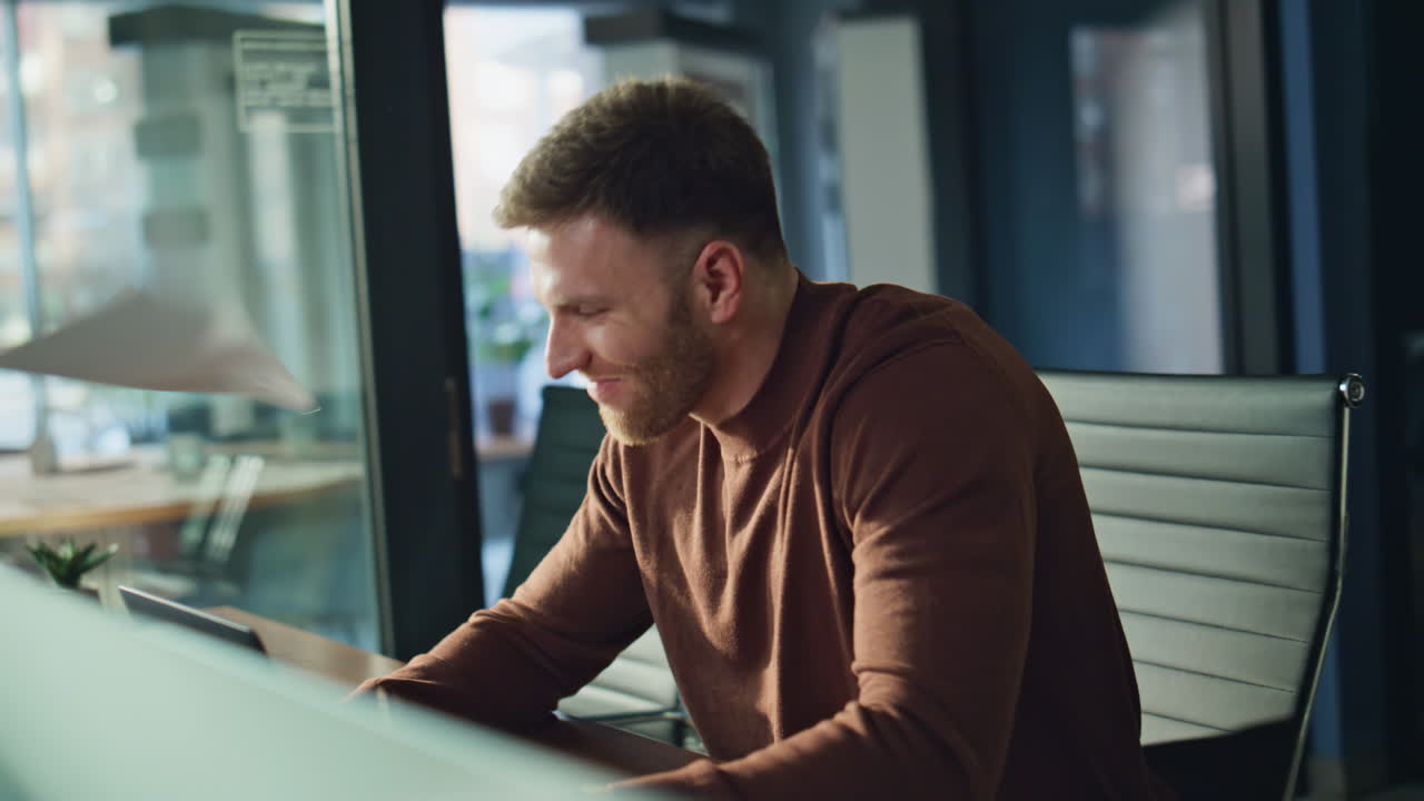 Overjoyed manager looking laptop holding documents at workplace office closeup