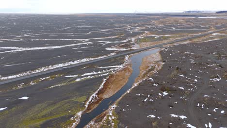 volcanic soil landscape, aerial drone, white car drive through icelandic nature