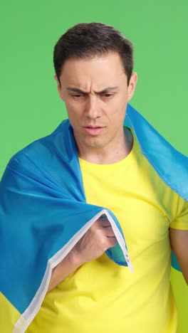 man wrapped in a ukrainian flag with pride and dignity