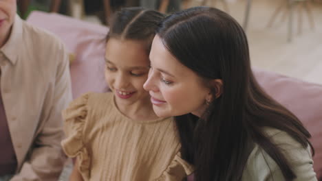 girl applying makeup on her mother's face