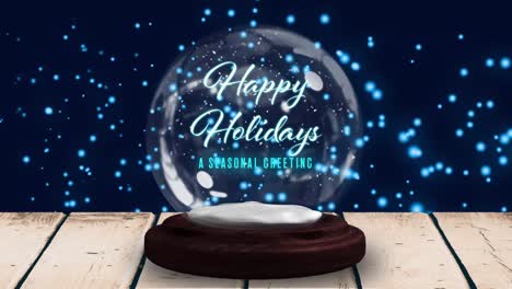 happy holiday text in snowball against blue glowing spots in background