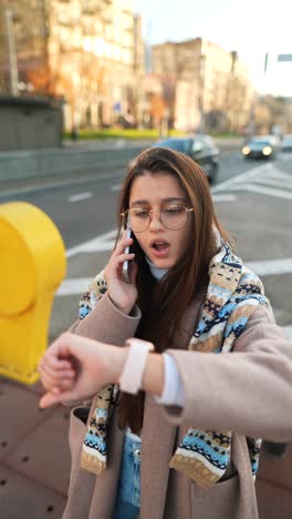 young woman talking on phone in city