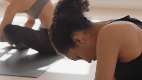 healthy yoga woman practicing poses young mixed race female enjoying fitness lifestyle exercising in studio with group of multiracial women