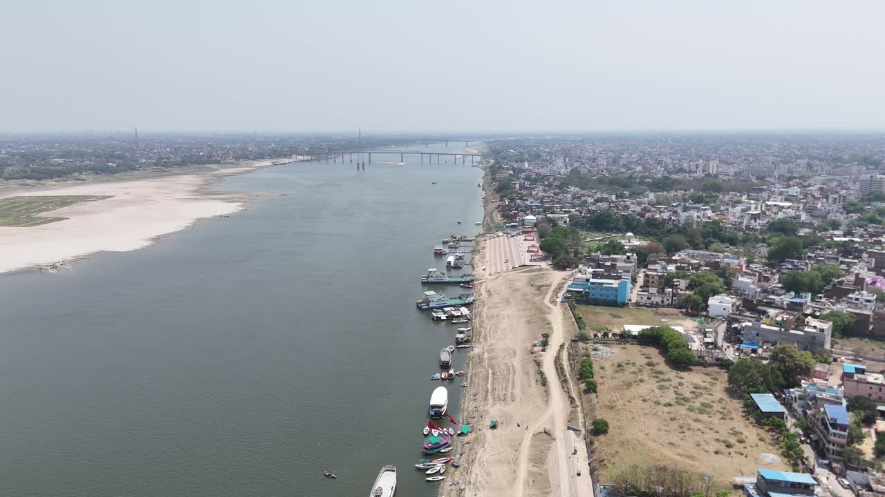 Overhead perspective of the Ganges River flowing through the heart of Varanasi, where the sacred and the everyday meet on the ancient stone steps.