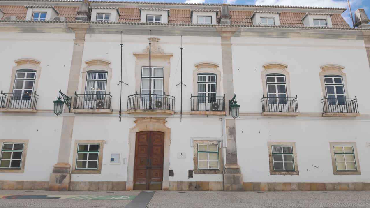 White facade of Portimão City Hall under blue sky in southern Portugal