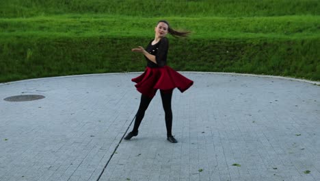 stunning female dancer practices outside in the park