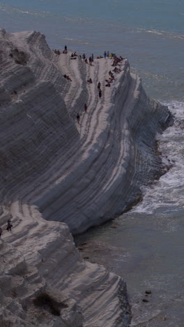 the beautiful white cliff steps of scala dei turchi beach in sicily in vertical