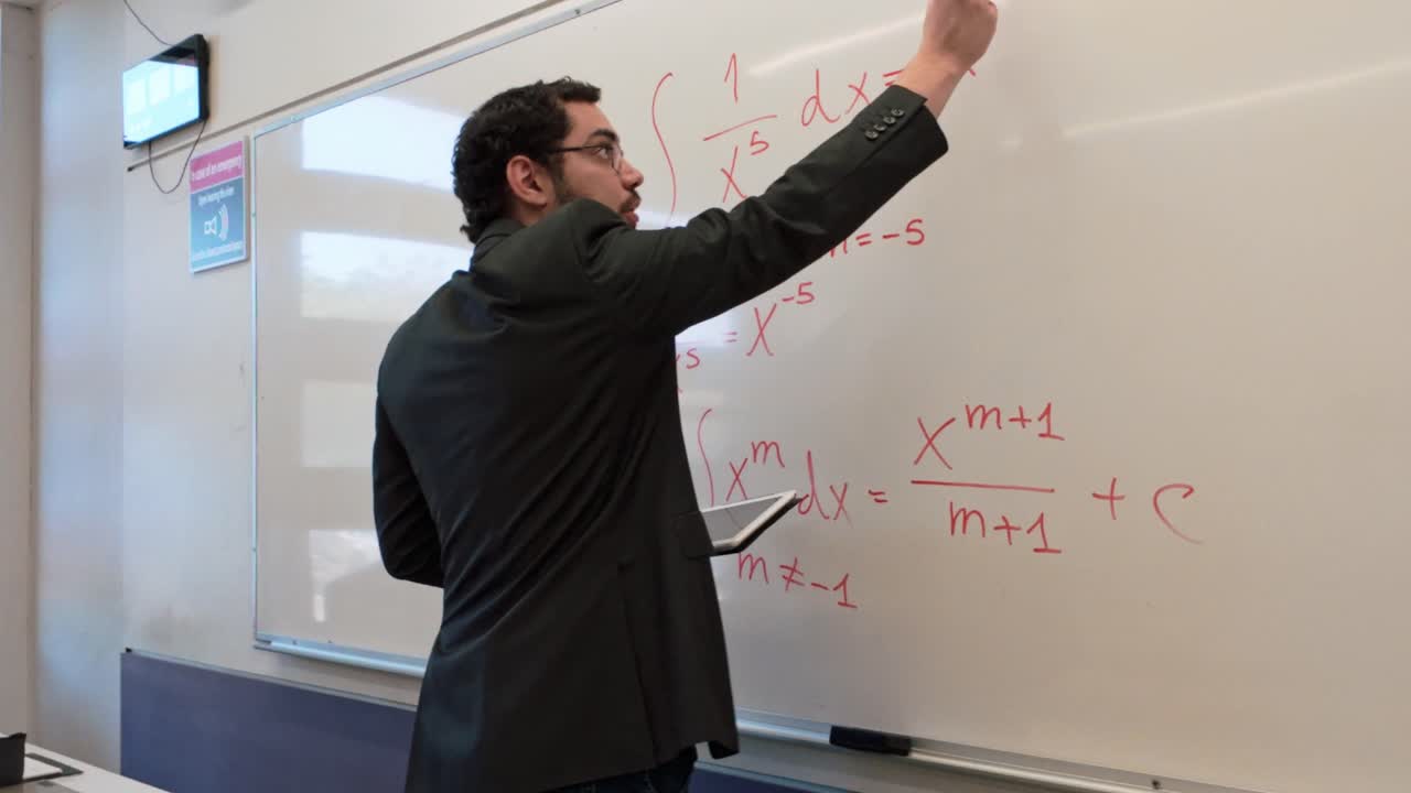 Modern Educator Using a Tablet While Teaching Math