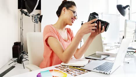 graphic designer looking at photos on digital camera