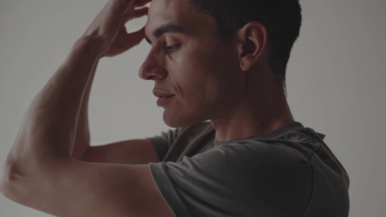 Giovane uomo che si tocca il viso in posa pensierosa
