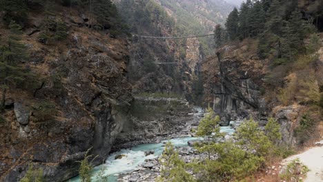 a view of the tenzing hillary swinging bridge in the mountains of nepal