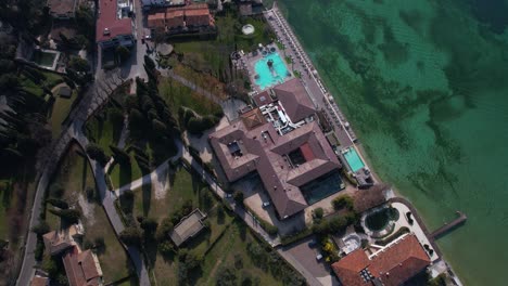 birdseye aerial view of hotel resort on coast of lake garda, sirmione, lombardy, italy