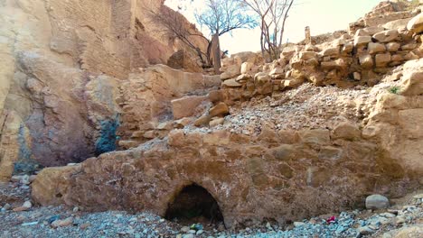 a canyon with ruined houses in a post apocalyptic setting