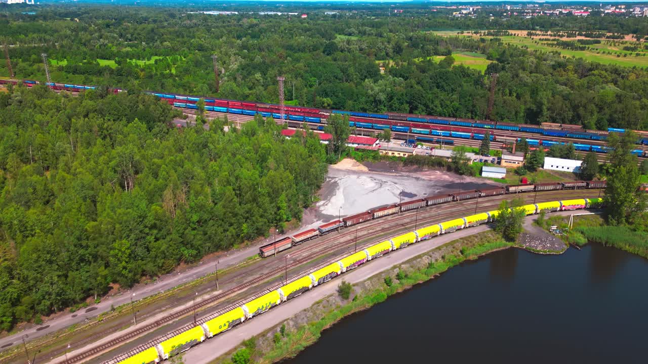 Mining and steel industrial freight trains amid green scenic landscape