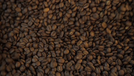 close up of coffee beans after roast mixing to cool down, slow motion detail