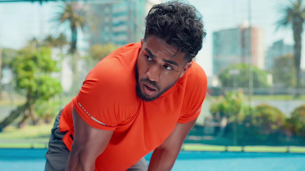 Tired Male Athlete Resting and Catching Breath After Workout