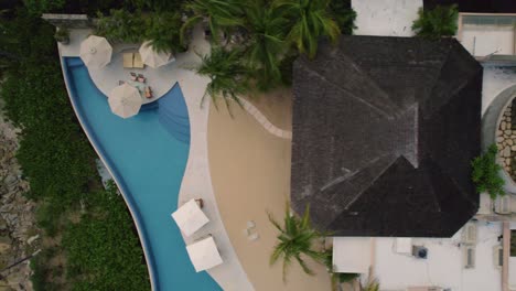 aerial crossing over luxirous touristic villa located at the mesmerizing coastline in huatulco, mexico