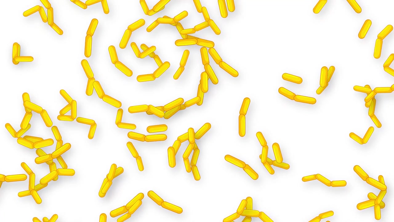 Oggetti gialli a forma di capsula cadono e rimbalzano su uno sfondo bianco pulito al rallentatore.