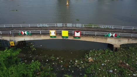 flying over an old bridge that was part of the french colony in district 2 of ho chi minh city