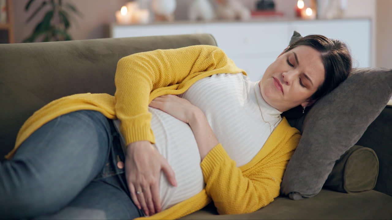 Pregnant woman relaxing on the sofa