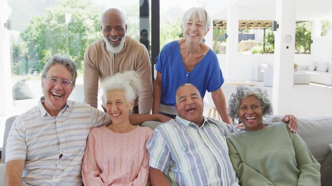Portrait of senior diverse people embracing at retirement home
