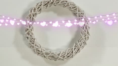 animation of hearts and wreath on white background