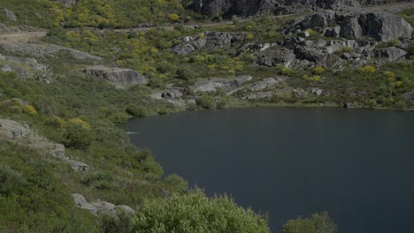 mountain lagoon surrounded by rocky terrain and sparse vegetation