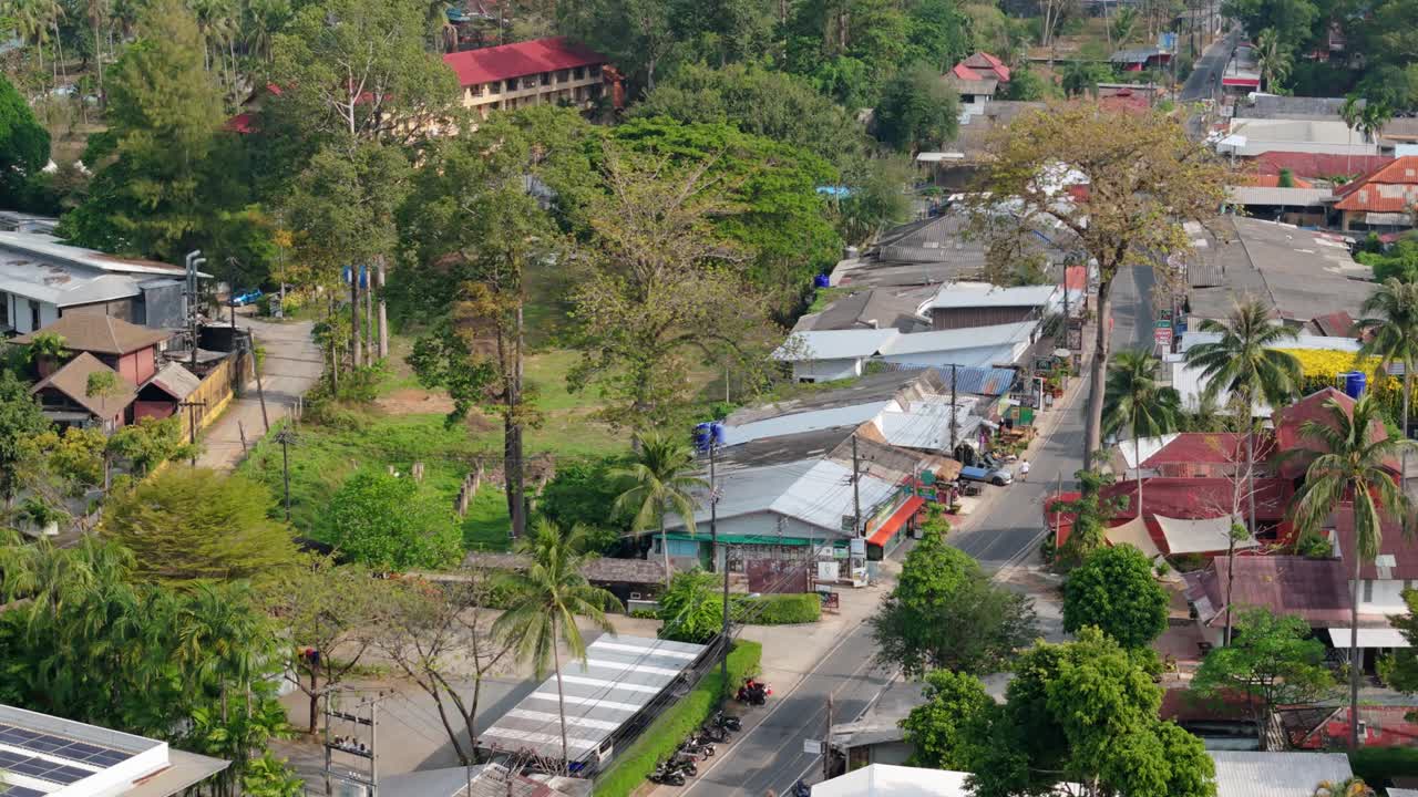 aerial footage of Kai Bae village a tourist hotspot on Koh Chang island, with roads, shops , hotel accommodation and roof tops