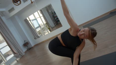 woman practicing yoga poses in a studio
