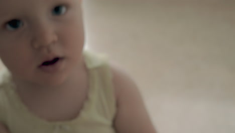 Happy-active-baby-girl-crawling-and-playing-in-the-kitchen-at-home