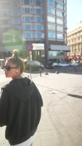 woman walking in a city street on a sunny day