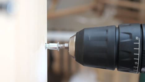 drilling a screw into wood with a power drill