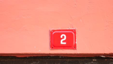 house number 2 on a coral wall