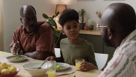 Black-men-and-boy-eating-lunch-at-home