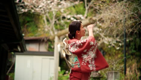 woman in kimono at a japanese temple during cherry blossom season