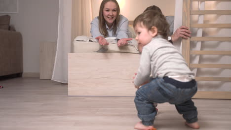 baby playing sitting on the floor plating with toys at home