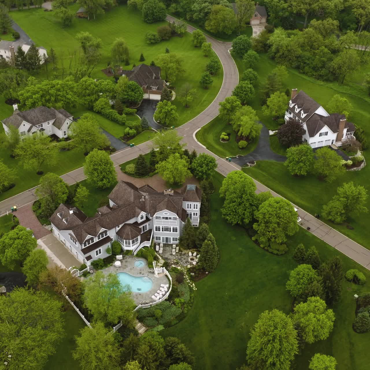 Beautiful private mansions located in the green suburb. Lovely houses connected with roads and paths and surrounded by greenery. Top view