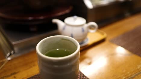 sequence of pouring tea from teapot to cup