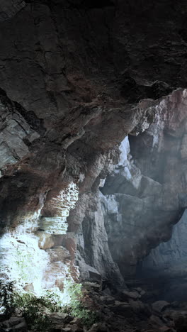 a narrow cave entrance with light streaming in