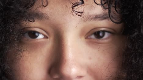 brown eyes from brown skinned curly woman