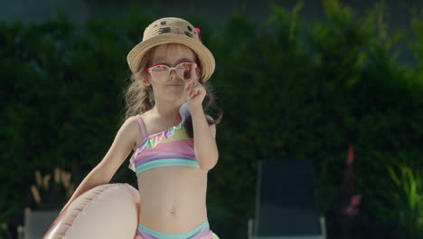 portrait of a cute little girl with an inflatable ring in her hands