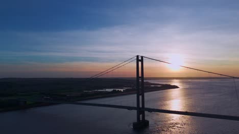 sunset's charm: aerial view of humber bridge with cars in motion