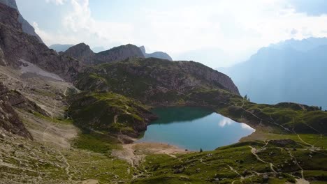 small blue water pond high in the mountains, lago di coldai, alleghe, italy