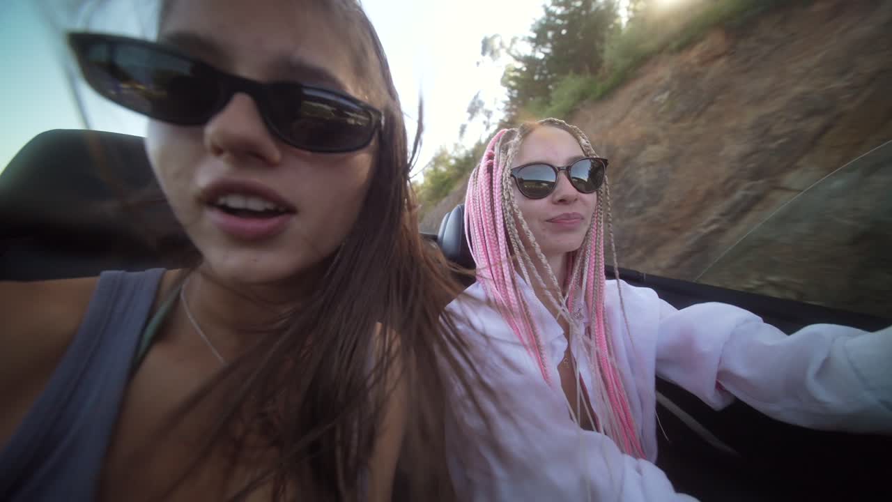 Women Enjoying a Playful Convertible Road Trip