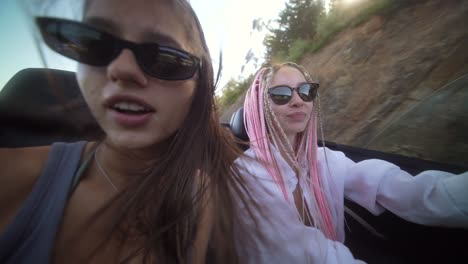 women enjoying a playful convertible road trip